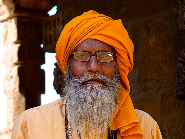 Dignified old man sheltering in the shade at the Qutab Minar