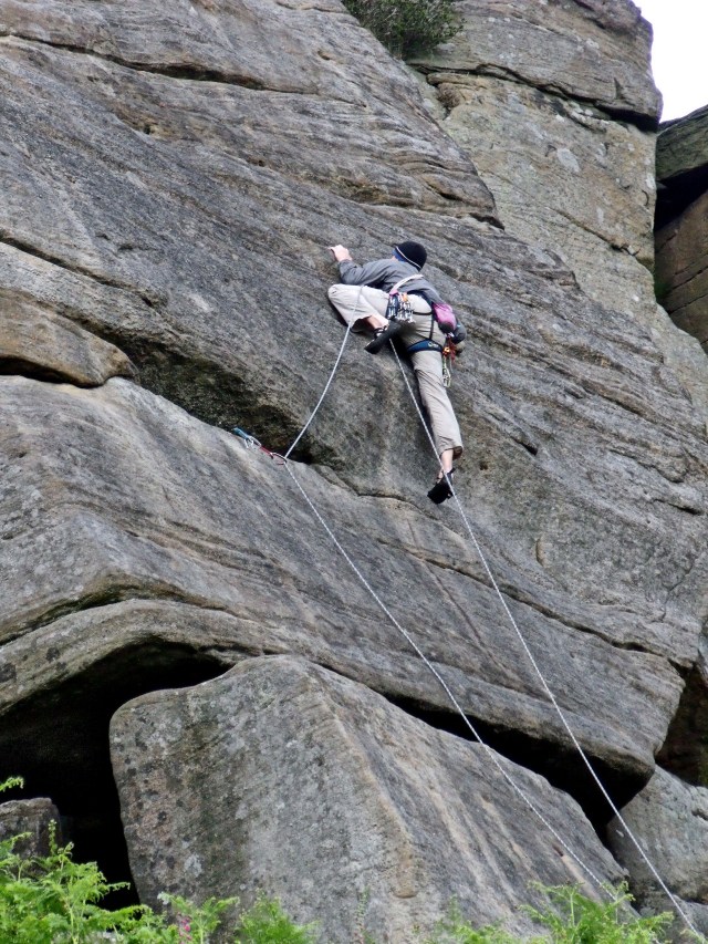 Climber on one of the world famous climbing routes on Stanage.