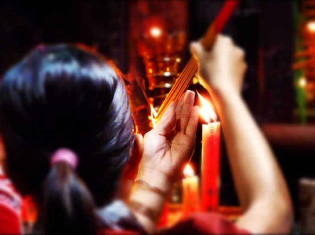 Lighting joss-sticks in the temple
