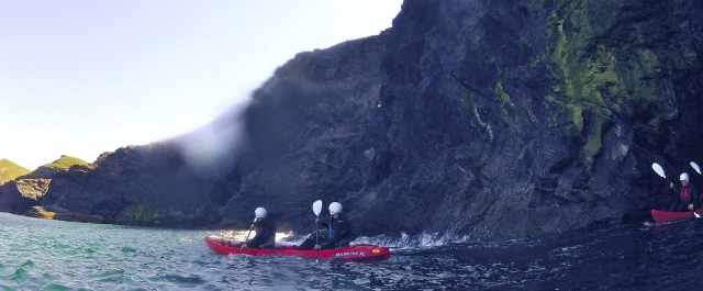 Paddling out of a sea-cave into open sea