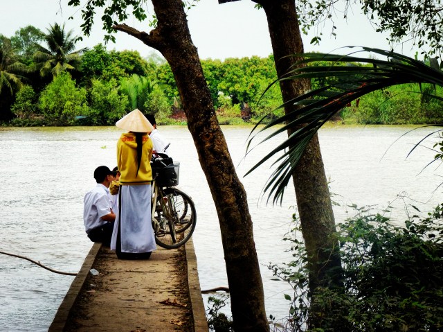 Locals waiting for a ferry along the mighty Mekong Locals waiting for a ferry along the mighty Mekong