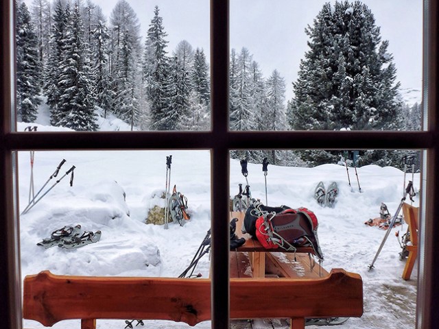 A snowy scene through a window of the Runch Hut